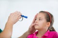 Eye doctor examining young girl patient - Ophthalmology