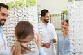 Eye Doctor With Woman Choosing Eyeglasses At Glasses Store Royalty Free Stock Photo