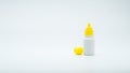 Eye drops bottle with open yellow cap isolated on white background with blank label and copy space Royalty Free Stock Photo