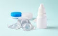 Eye drops with contact lenses and accessories on blue background Royalty Free Stock Photo