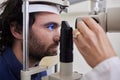 Eye exam, care or laser test for patient with machine at optometry consultation for lens or vision. Face of man and