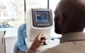 Eye exam by a doctor looking and checking the vision of a patient at a sight specialist office. Medical healthcare