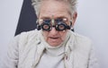 Eye exam, trial frame and senior woman in optometry clinic for vision test, eyesight and optical assessment Royalty Free Stock Photo