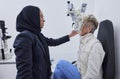 Eye exam, vision and woman with Muslim optometrist in clinic for test, eyesight and optical assessment. Optometry Royalty Free Stock Photo