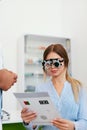 Eye Exam. Woman In Optometry Glasses Reading Eye Test Card Royalty Free Stock Photo