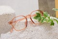 eye glasses on a concrete podium on a beige background, trend composition, stylish eye glasses on a beige background