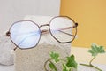 eye glasses on a concrete podium on a beige background, trend composition, stylish eye glasses on a beige background