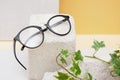 eye glasses on a concrete podium on a beige background, trend composition, stylish eye glasses