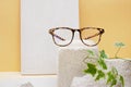 eye glasses on a concrete podium on a beige background, trend composition, stylish eye glasses