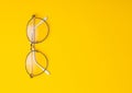 Eye glasses isolated on yellow background with copyspace. Royalty Free Stock Photo