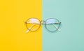 Eye glasses isolated on yellow and blue background. Royalty Free Stock Photo