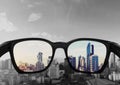 Eye glasses looking to city view, focused on glasses lens