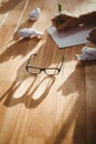 Eye glasses by man writing at desk in office Royalty Free Stock Photo