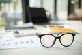 eye glasses placed on the desk are eye glasses that are prepared for people with farsightedness to work and read documents clearly Royalty Free Stock Photo