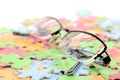 Eye glasses and puzzle Royalty Free Stock Photo