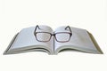 Opened thick book and eye glasses