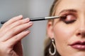 Because the eye has to be striking. Closeup shot of a beautiful young bride applying make-up while preparing for her