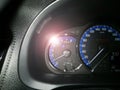 Eye-level angle, close-up, temperature car symbol, and white lens flare Royalty Free Stock Photo