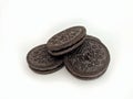 Eye level image of stacked of tasty chocolate sandwich cookies in a white background