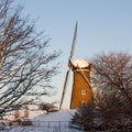 Eye-level shot of the windmill of Hoofddorp near trees in winter, Holland, Netherlands Royalty Free Stock Photo