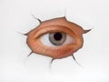 Eye looking through hole on paper Royalty Free Stock Photo