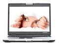 Eye looking through hole in screen of laptop Royalty Free Stock Photo