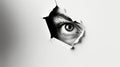 An eye looking through a torn hole in paper or wall. Royalty Free Stock Photo