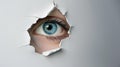 An eye looking through a torn hole in paper or wall. Royalty Free Stock Photo