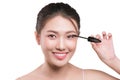 Eye make up apply. Mascara brush. Portrait of beautiful asian w Royalty Free Stock Photo