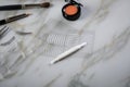 Eye shadow palette, brushes, fake lashes, tweezers and artificial eyelid crease double tapes for eye makeup on marble beauty desk Royalty Free Stock Photo