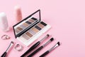 Eye shadow palette and makeup accessories on pastel pink background Royalty Free Stock Photo