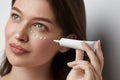 Eye Skin Care. Beautiful Woman Applying Eye Cream