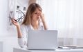 Overworked Girl Massaging Nosebridge Sitting At Laptop At Workplace Royalty Free Stock Photo