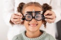 Eye, vision and test with child for glasses in optometry office for eye care and health. Eyewear, exam and medical