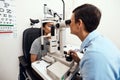 Eye and vision test, exam or screening with an optometrist, optician or ophthalmologist and a patient using an Royalty Free Stock Photo