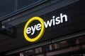 Eye Wish Opticien store, with illuminated shop logo.
