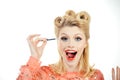 Eyebrow makeup. Blonde excited woman brushing brows with brows brush closeup. Pin up style. Royalty Free Stock Photo