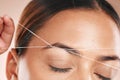 Eyebrows, grooming and woman threading hair on face for beauty routine, shaping and cosmetics care on a studio