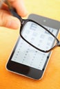 Eyechart on mobile screen with eyewear Royalty Free Stock Photo