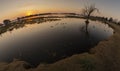 Eyefish shot of a lagoon with ducks, capibaras, birds and waterplants at sunset in Las Flores, Buenos Aires, Argentina