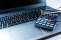 Eyeglass, pencil, calculator on laptop computer keyboard, business background image,