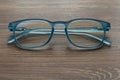 Eyeglassed blue color on wooden table office Royalty Free Stock Photo