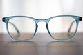 Eyeglassed blue color on wooden table office Royalty Free Stock Photo