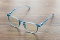 Eyeglassed blue color on wooden table office Royalty Free Stock Photo