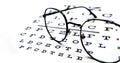 Eyeglasses with black frame and eye test chart. Royalty Free Stock Photo