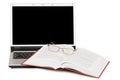 Eyeglasses and books on the laptop Royalty Free Stock Photo