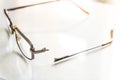 Eyeglasses with a broken handle on a bright background Royalty Free Stock Photo