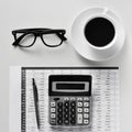 Eyeglasses, coffee and calculator on an office desk Royalty Free Stock Photo