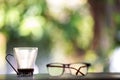 Eyeglasses, Coffee glasses cup with coffee stains stuck on them, then after drinking it on wooden table in bokeh blurred green Royalty Free Stock Photo