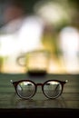 Eyeglasses, Coffee glasses cup with coffee stains stuck on them, then after drinking it on wooden table in bokeh blurred green Royalty Free Stock Photo